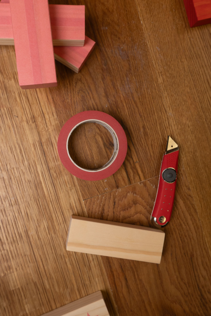 Materials needed for giant jenga game, wood blocks, cutting knife, painterst tape, wood stain