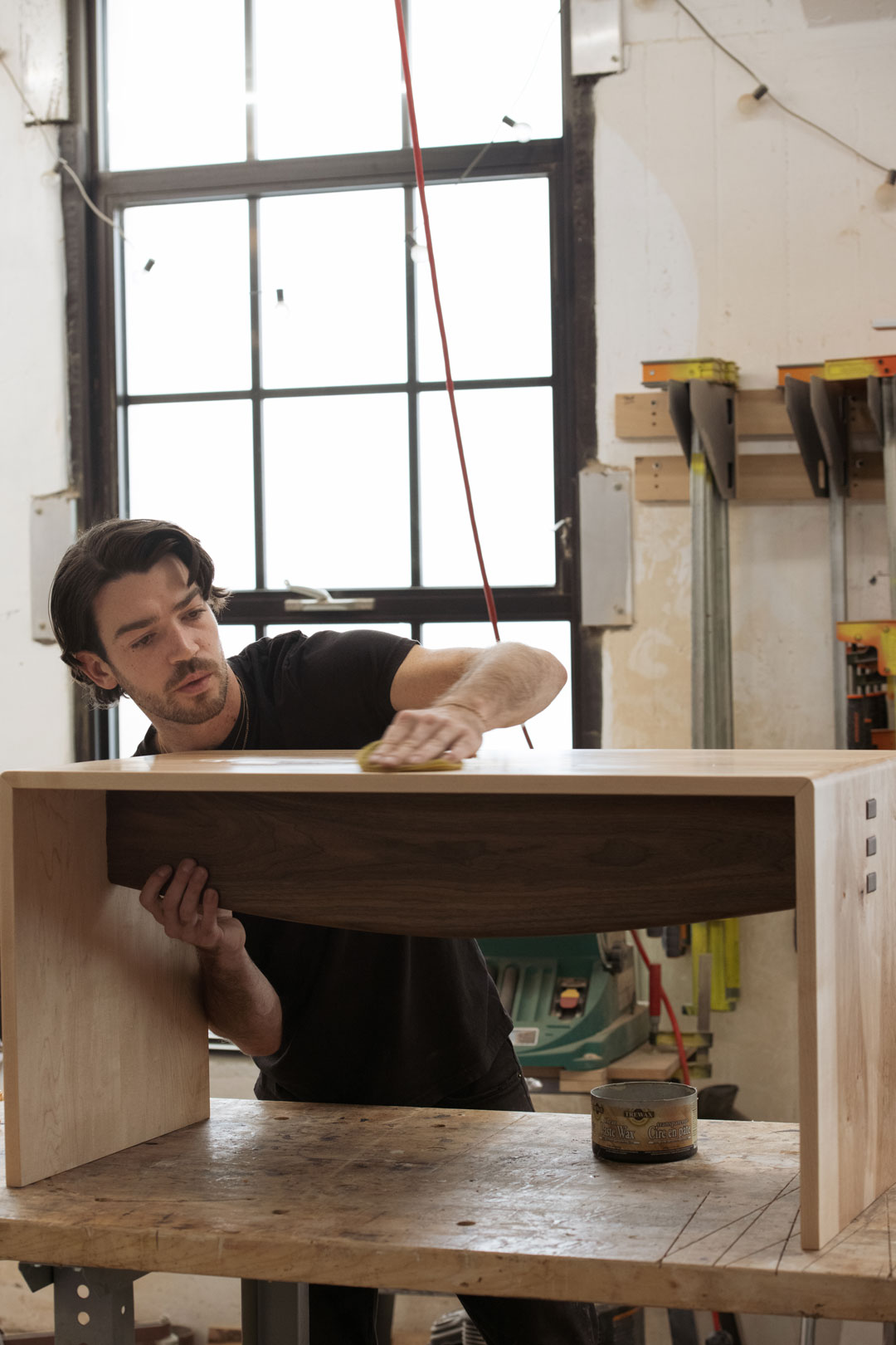 image1web Simon Barrie applying wood finish in his Brooklyn studio.